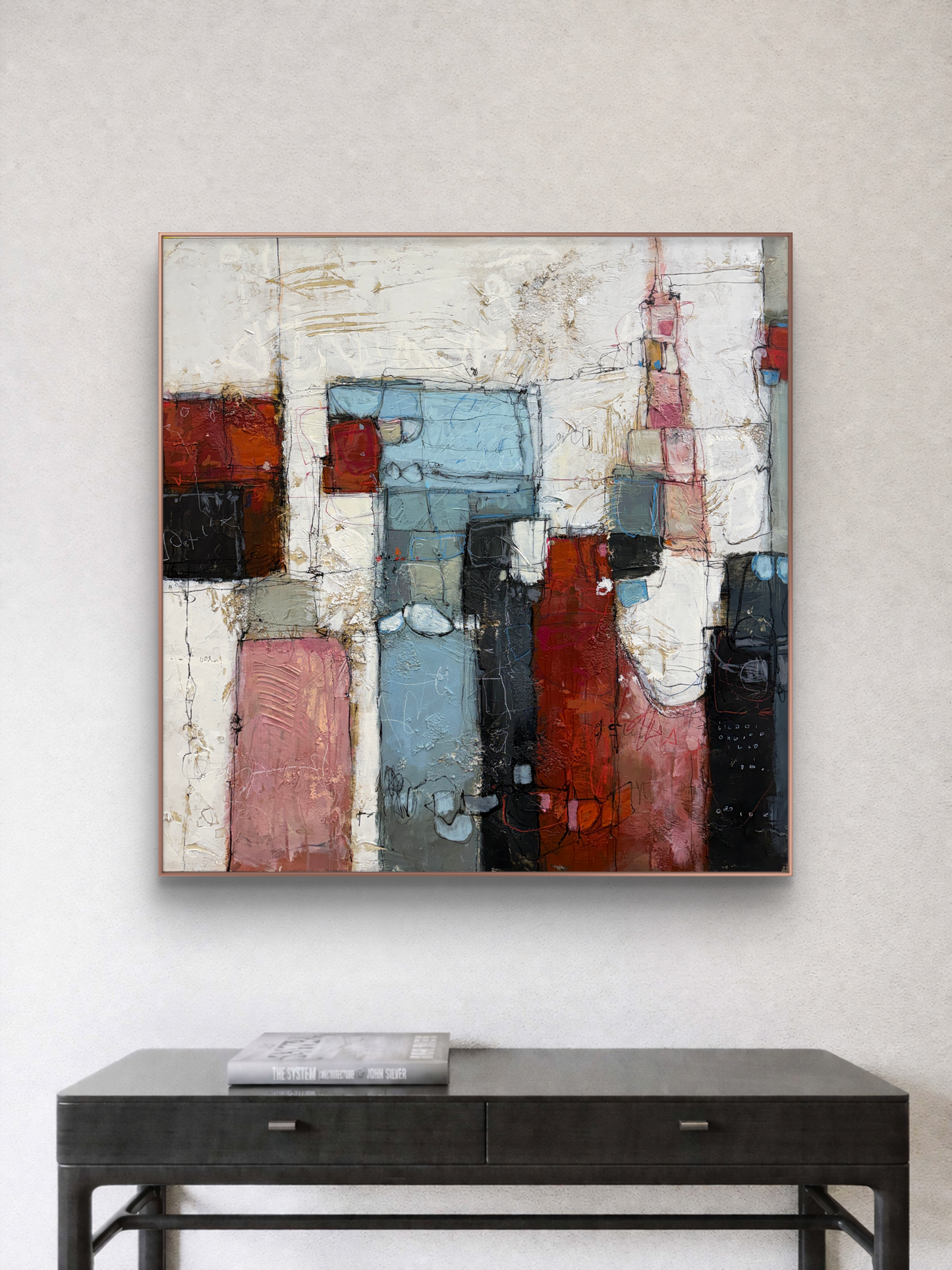 Abstract painting with geometric shapes on a wall above a black console table.