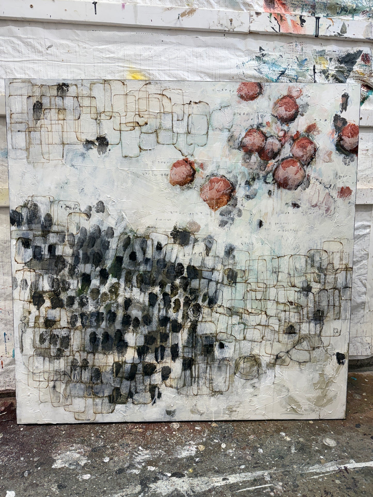 Artistic abstract painting with various textures and colors on a textured surface