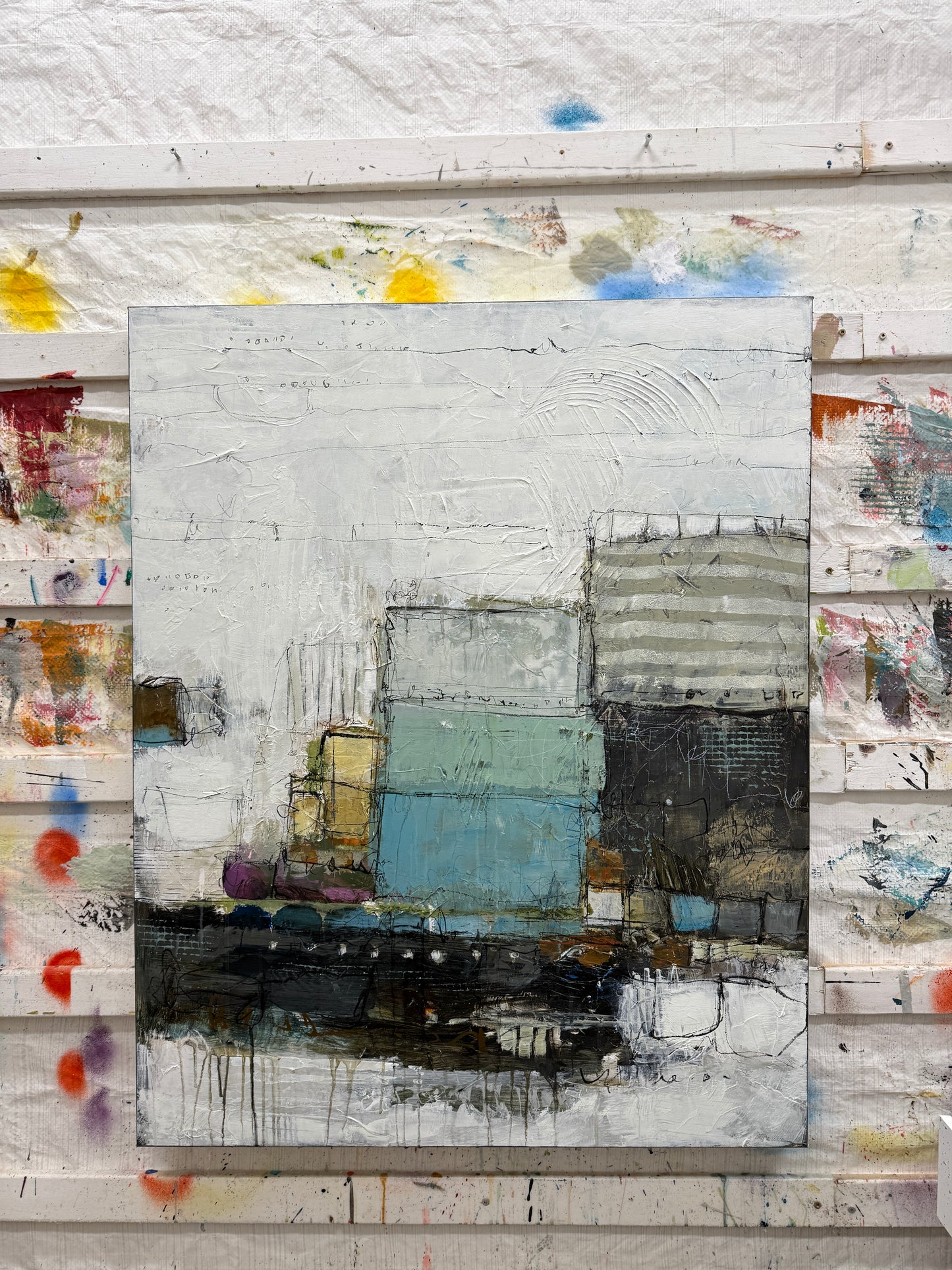 Abstract art piece with a central rectangular panel surrounded by various colors and textures.
