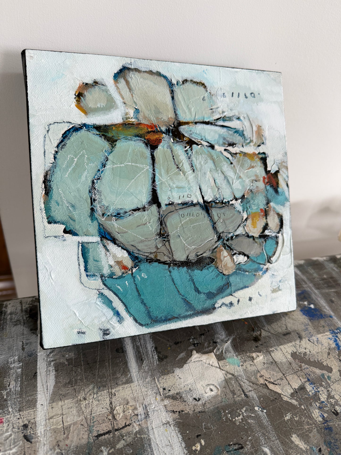 Abstract painting of a flower with blue and gray tones on a white background 8x8 Lori Mirabelli