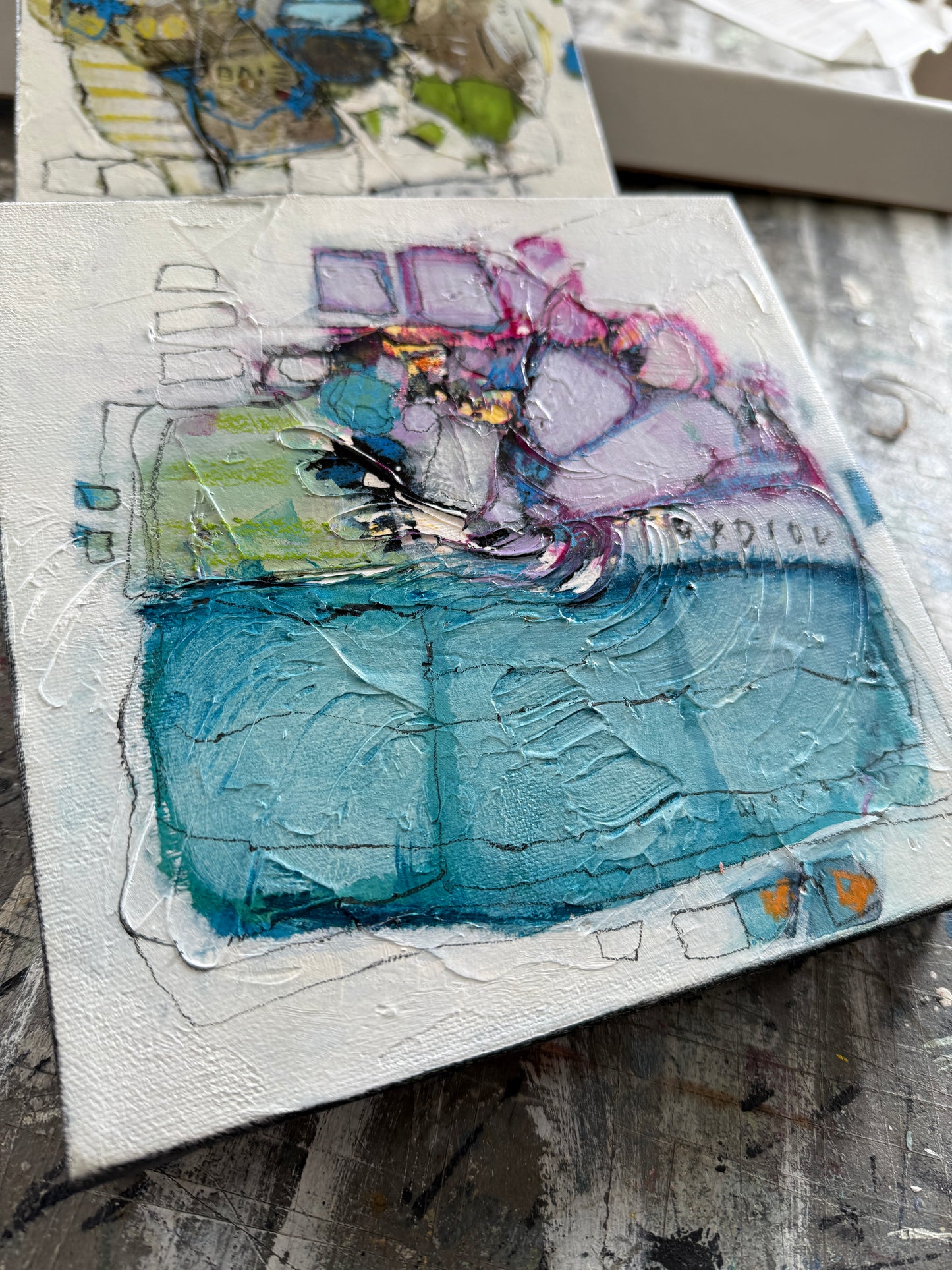 Abstract art piece with textured blue and multicolored elements on a white background