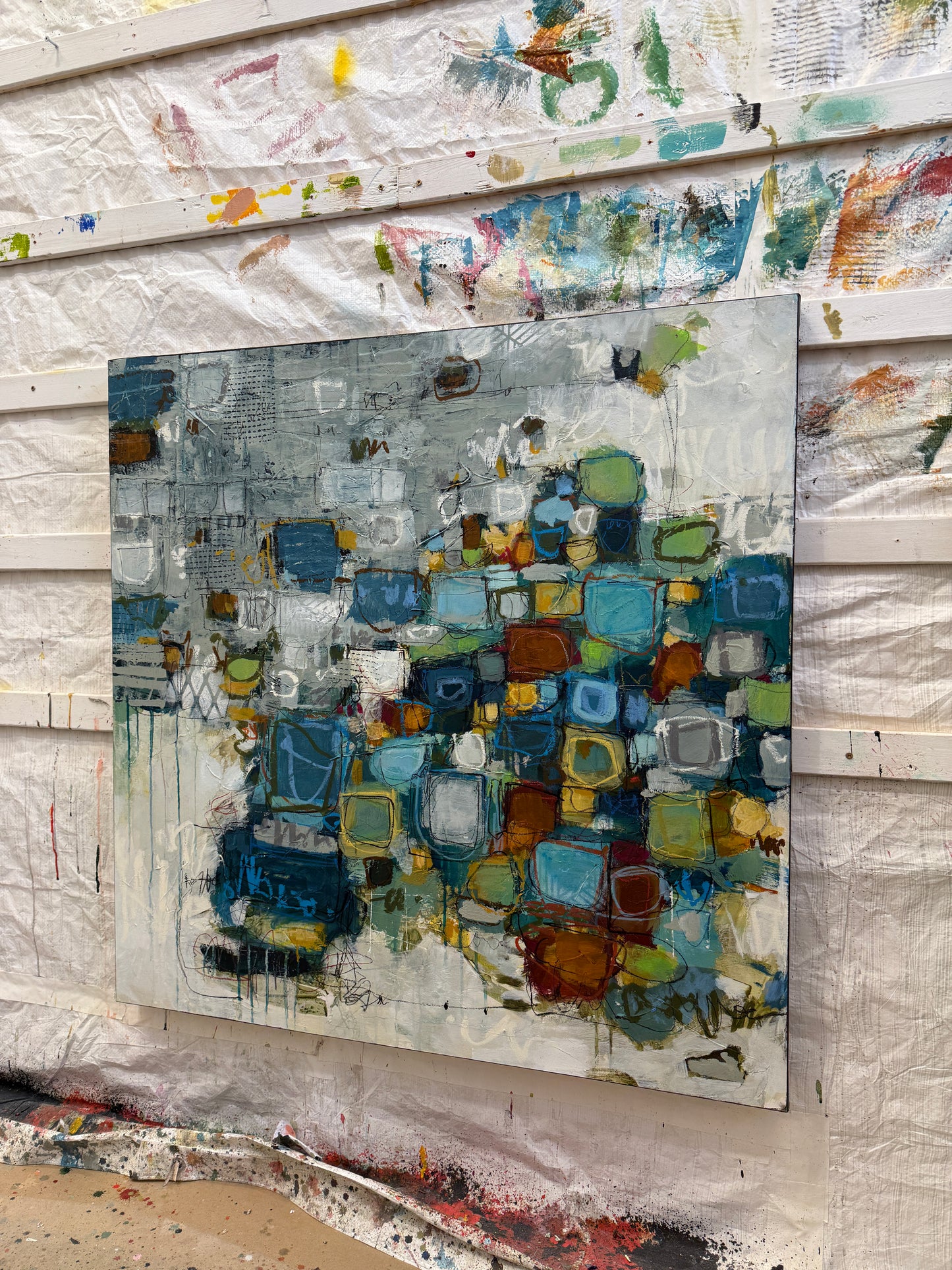 Abstract art piece with colorful geometric patterns on a textured surface
