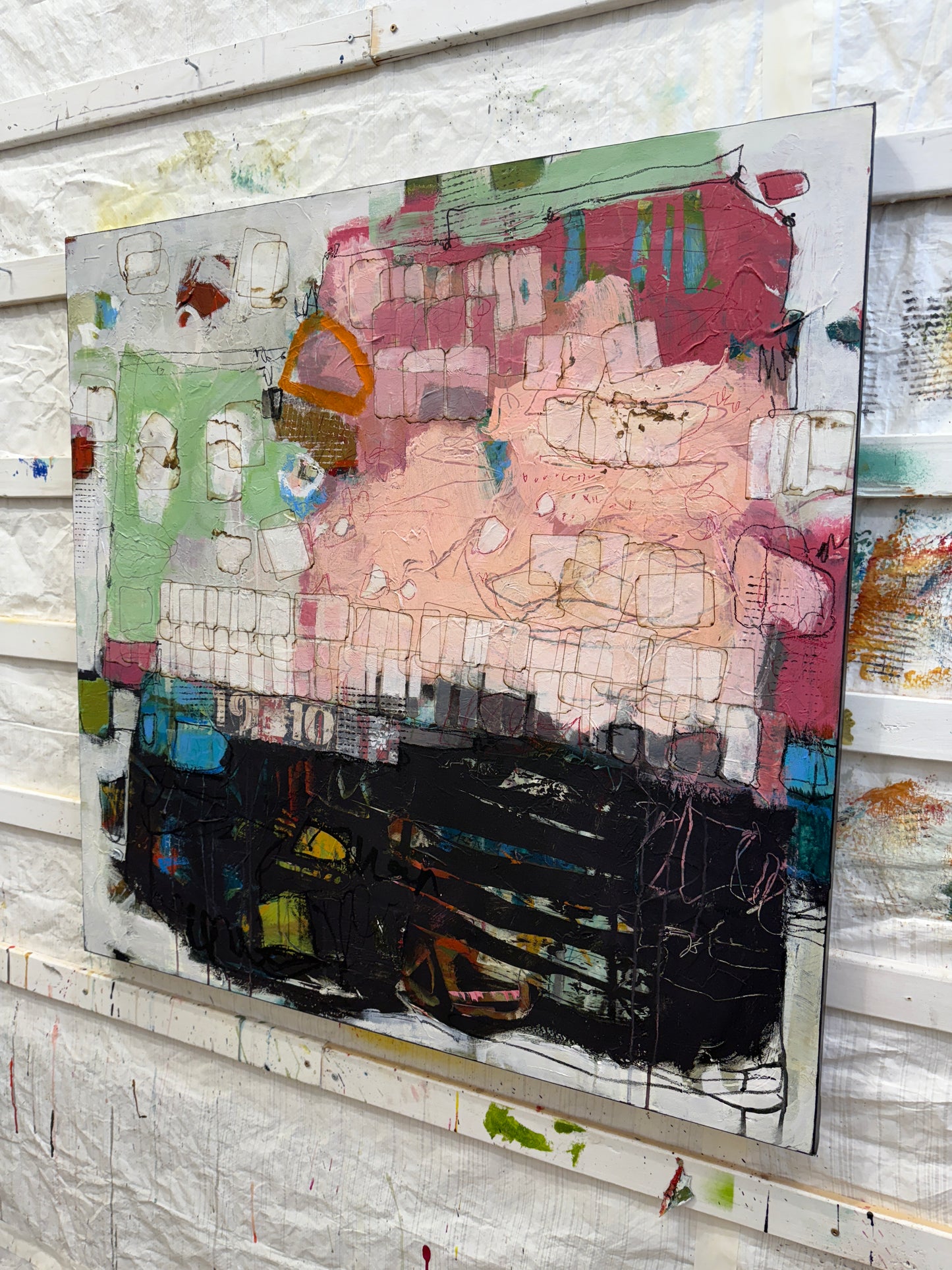 Abstract artwork with colorful patterns on a textured surface