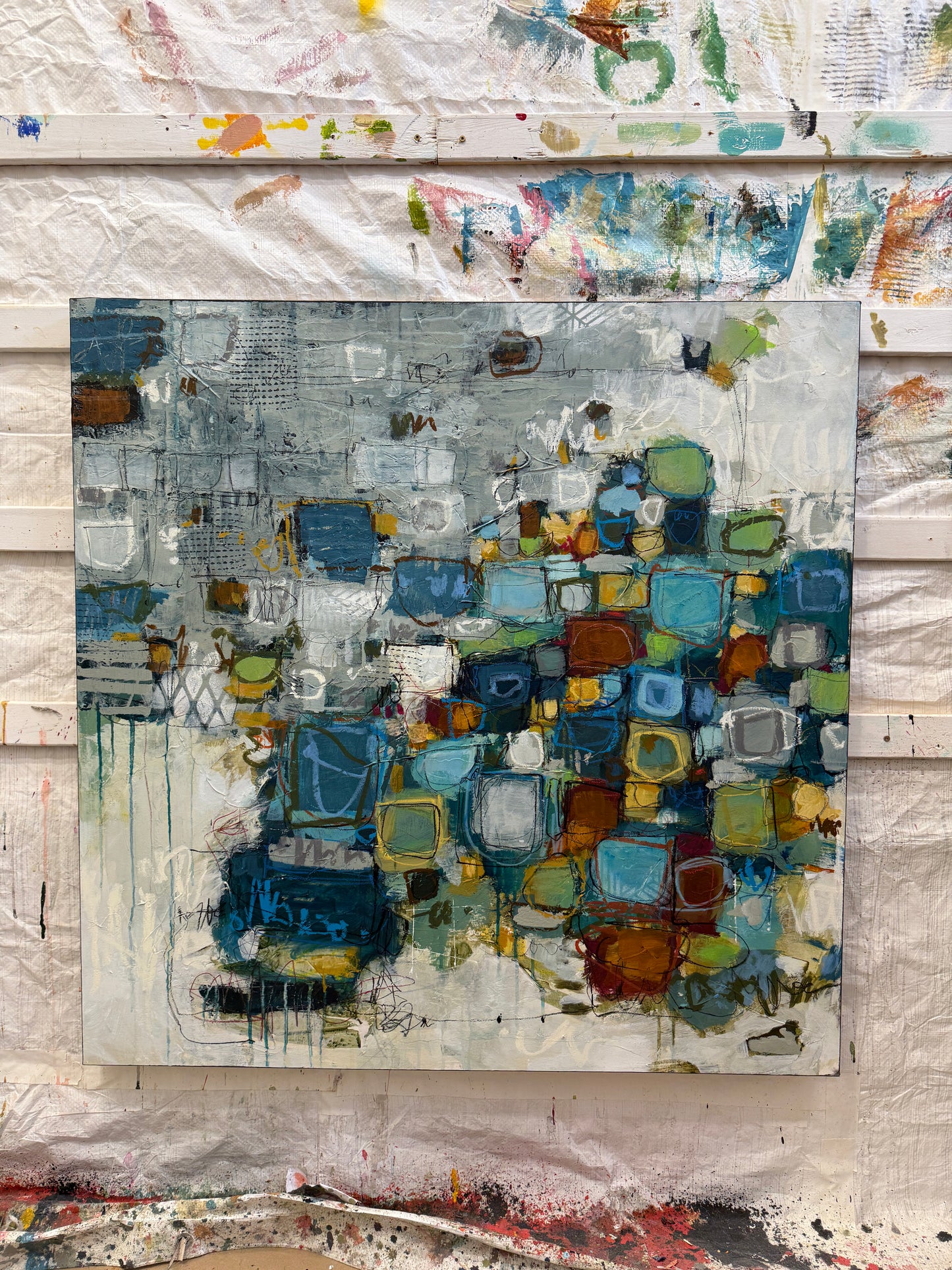 Abstract art piece with geometric shapes on a textured surface