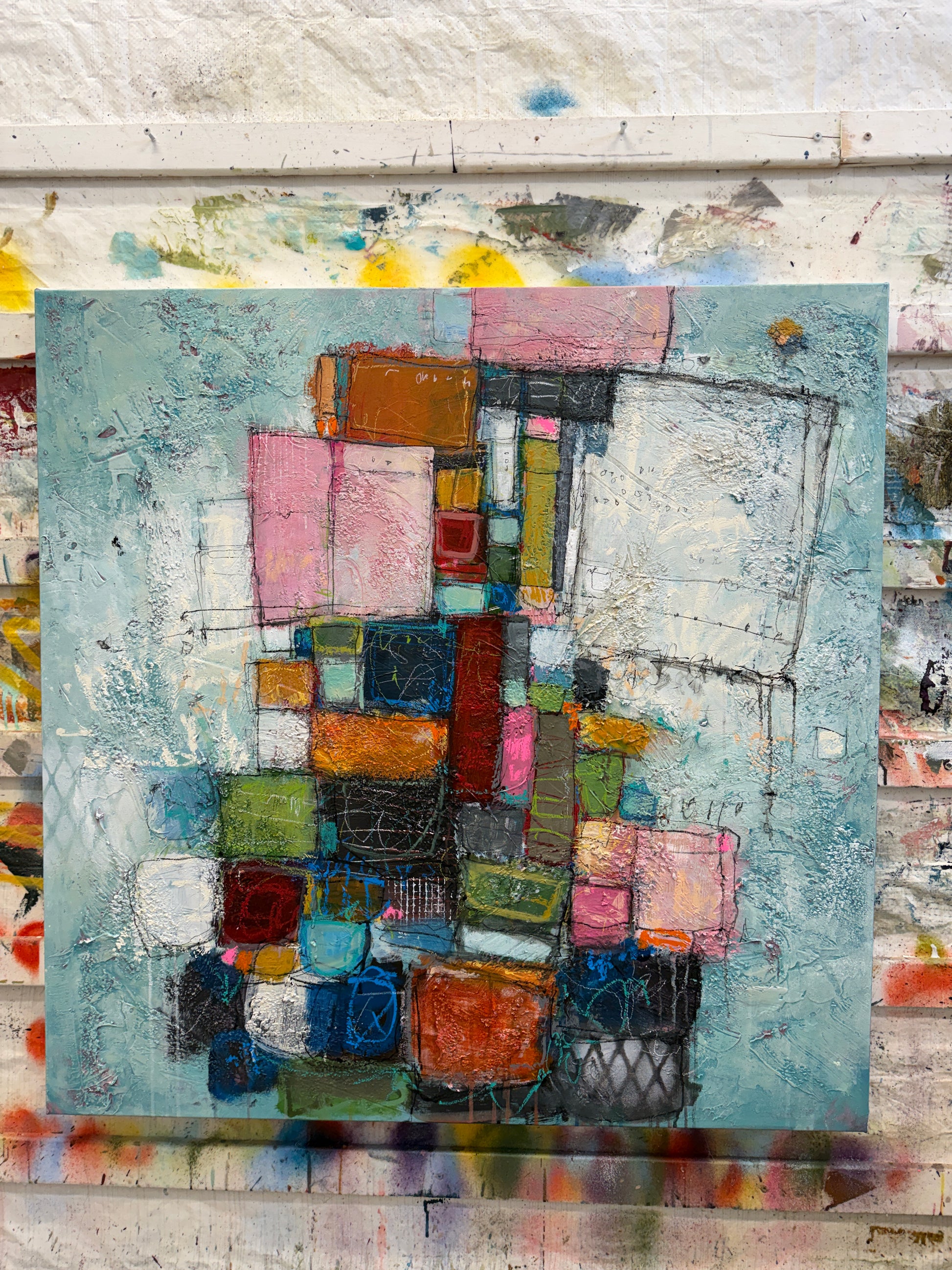 Abstract art piece with colorful geometric shapes on a textured background