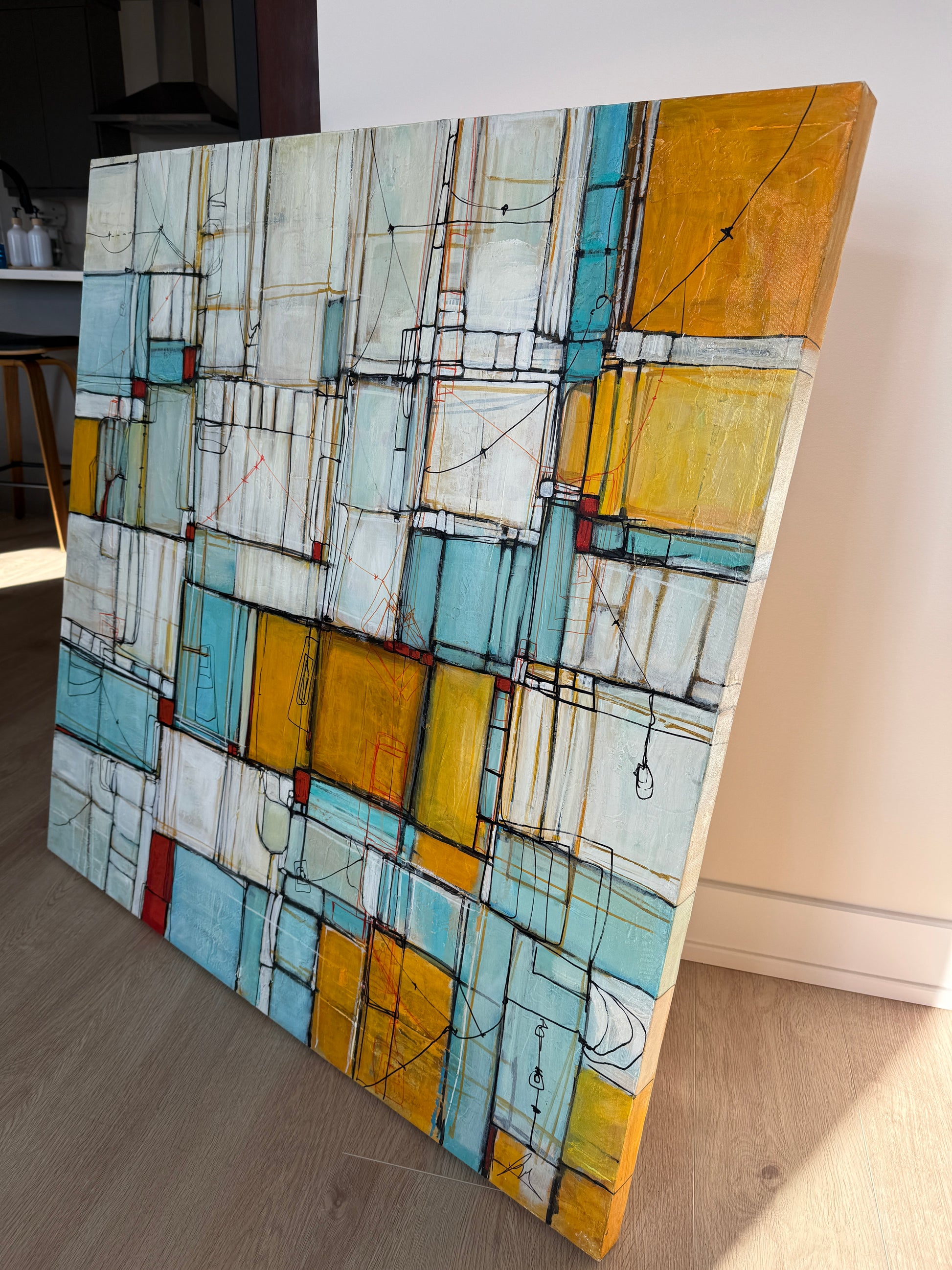 Abstract art piece with geometric shapes on a wooden surface