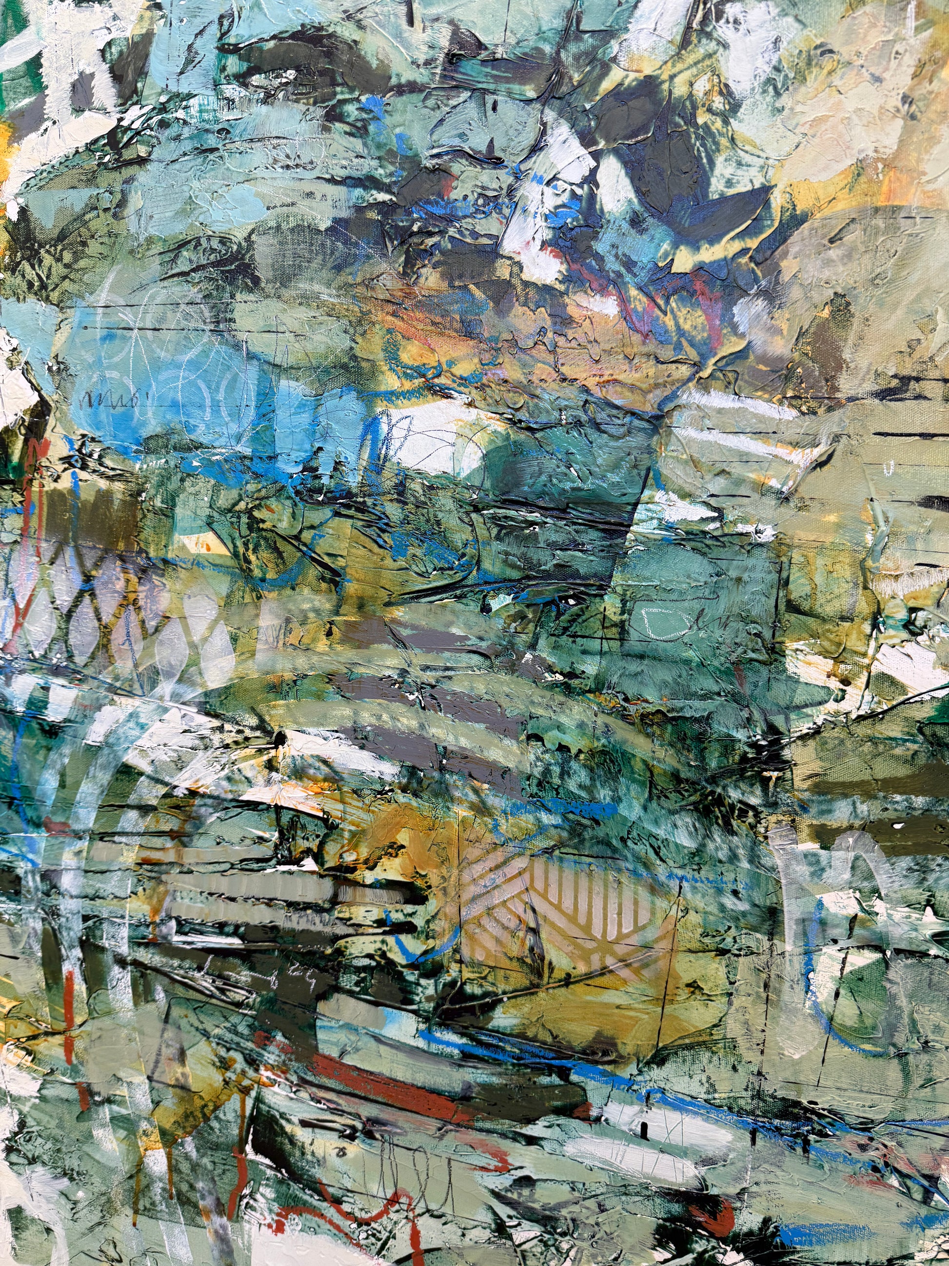A large 36 x 60” abstract acrylic painting featuring layered greens, blues, whites, and hints of ochre. The piece has a dynamic, organic feel with visible mark-making and movement, blending structured lines with expressive brushwork. Displayed on a white studio wall above wooden steps. Lori mirabelli