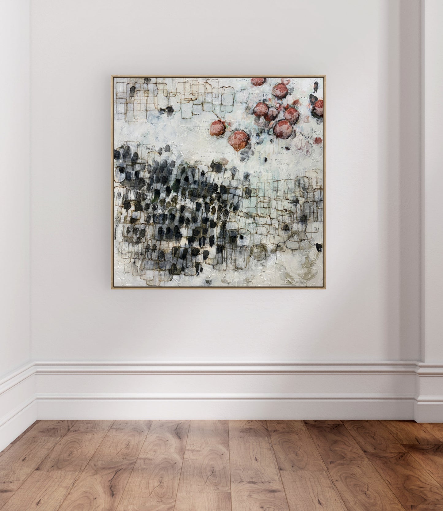 Abstract art piece on a white wall with wooden flooring