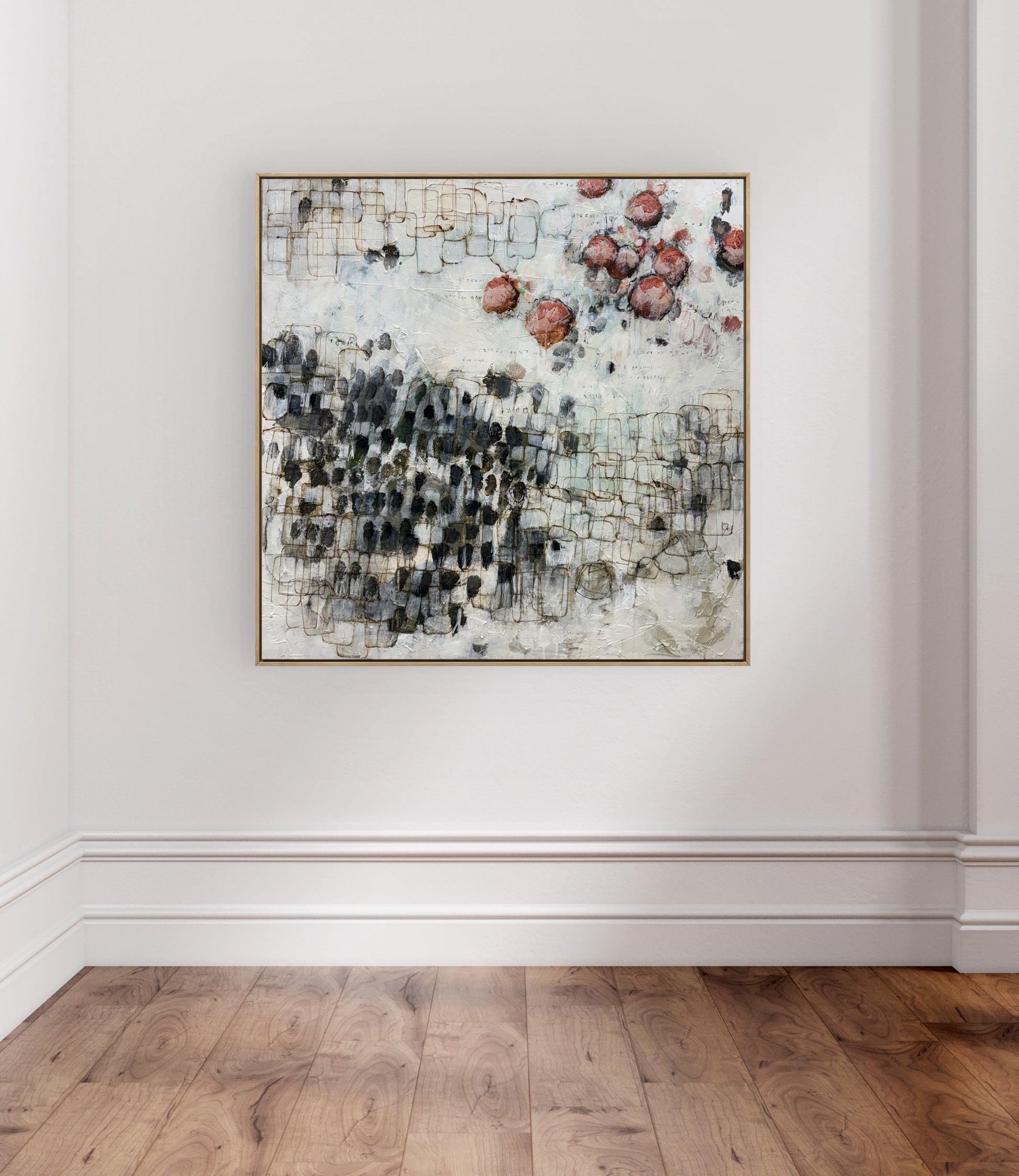 Abstract art piece on a white wall with wooden flooring