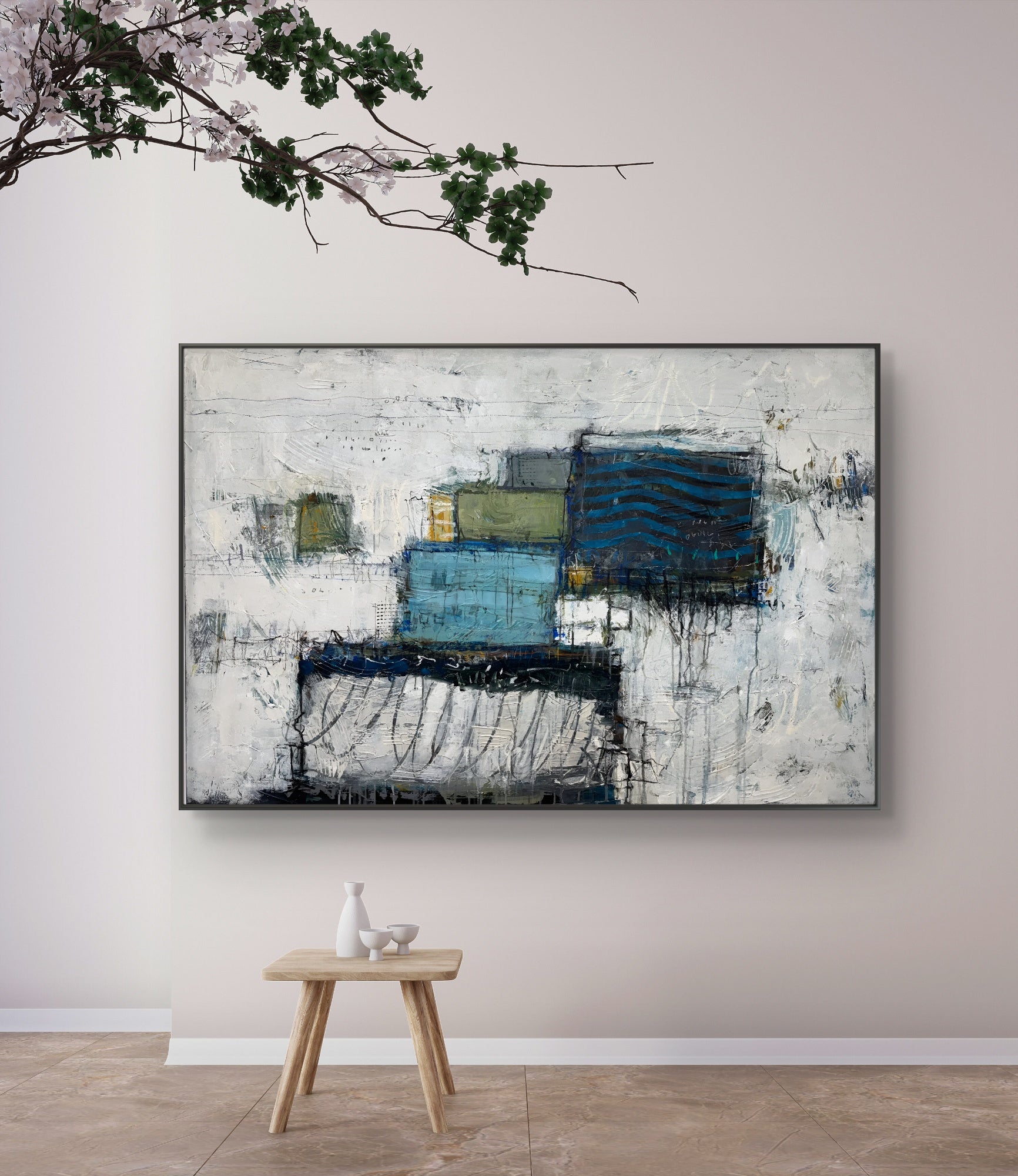 Abstract painting on a wall with a small wooden table and decorative items below.