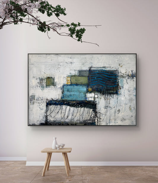Abstract painting on a wall with a small wooden table and decorative items below.