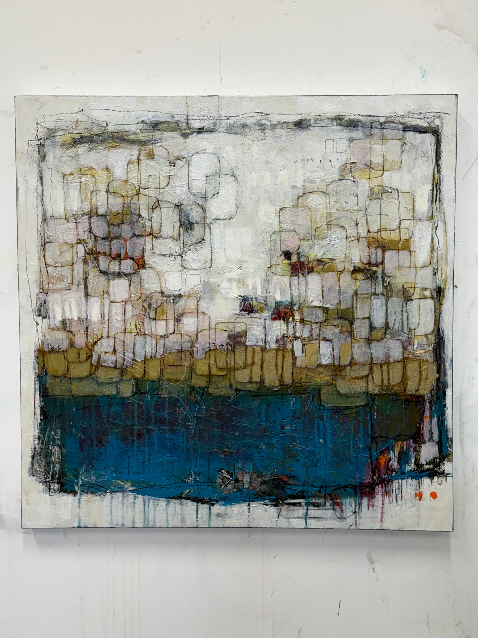 Abstract art piece with geometric shapes on a white wall