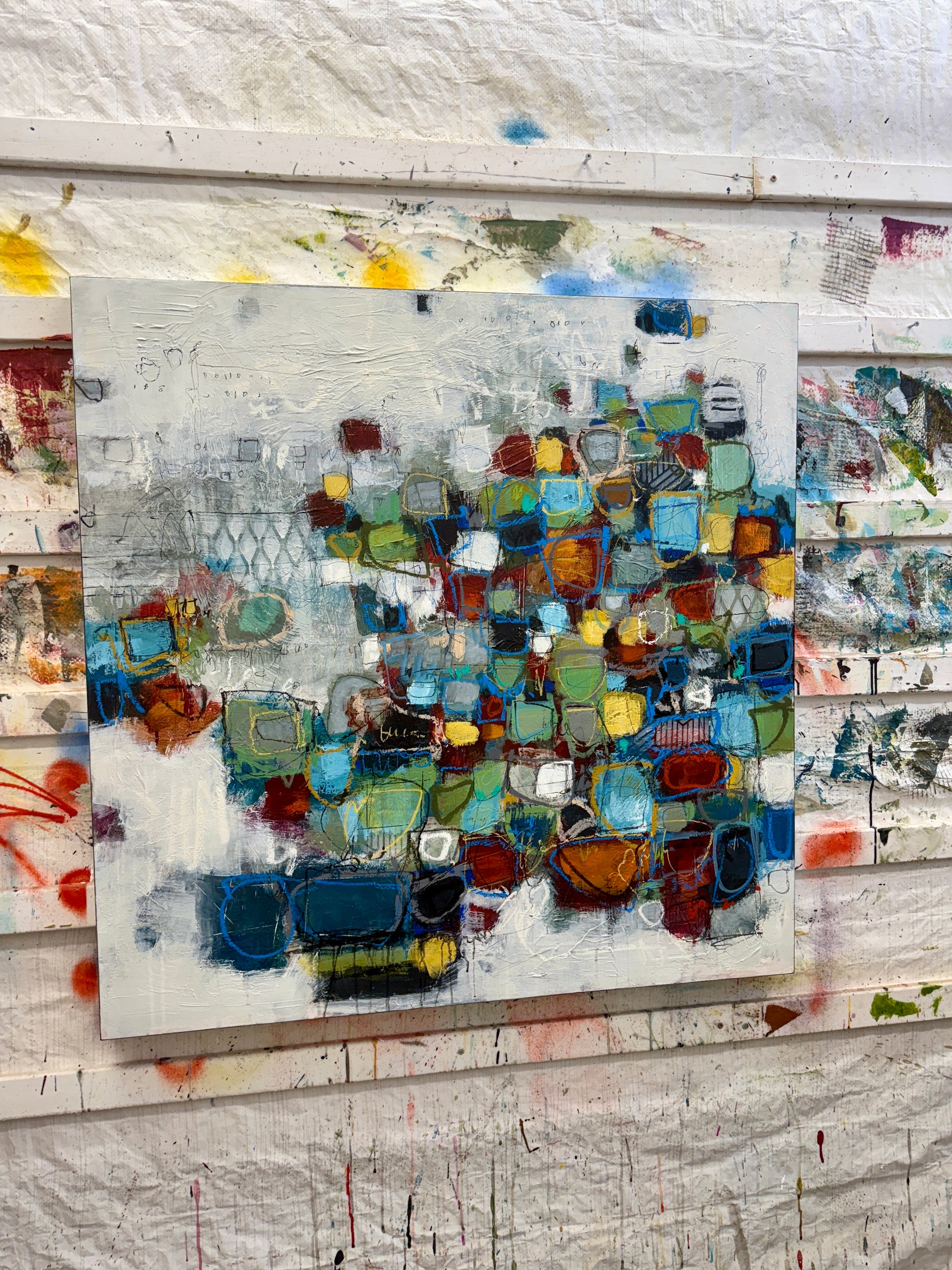 Original abstract mixed-media painting for sale, featuring layered geometric shapes in blues, greens, ochres, and rust tones on a textured neutral background.