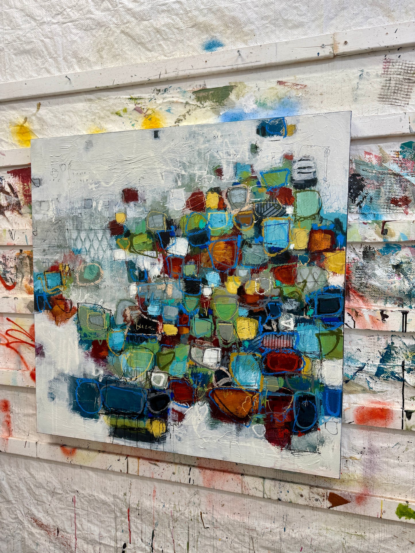 Original abstract mixed-media painting for sale, featuring layered geometric shapes in blues, greens, ochres, and rust tones on a textured neutral background.