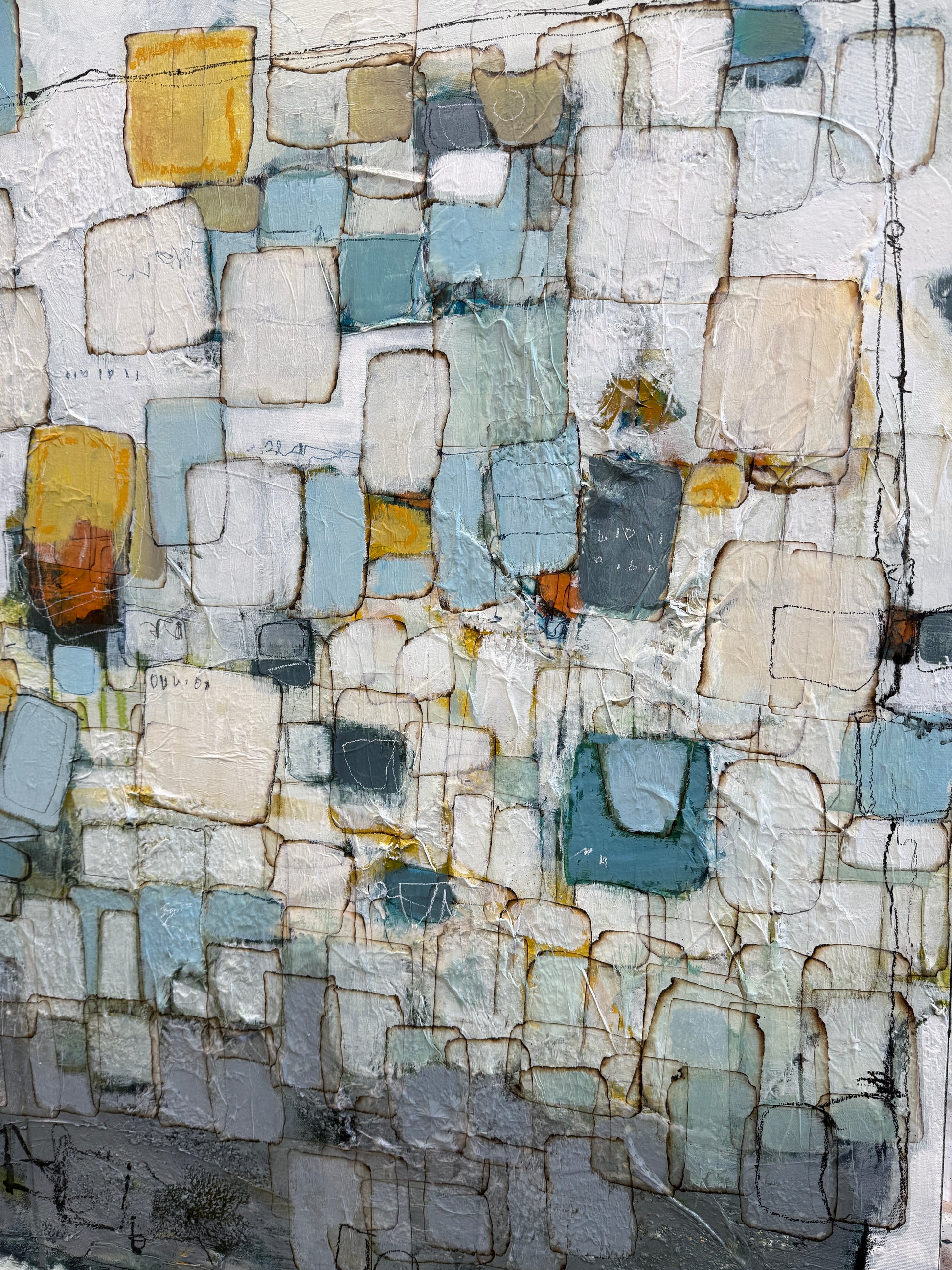 Abstract textured painting with a mosaic of irregular rectangular blocks in off-white, light blue, gray, teal, beige, and muted yellow, separated by dark linework.