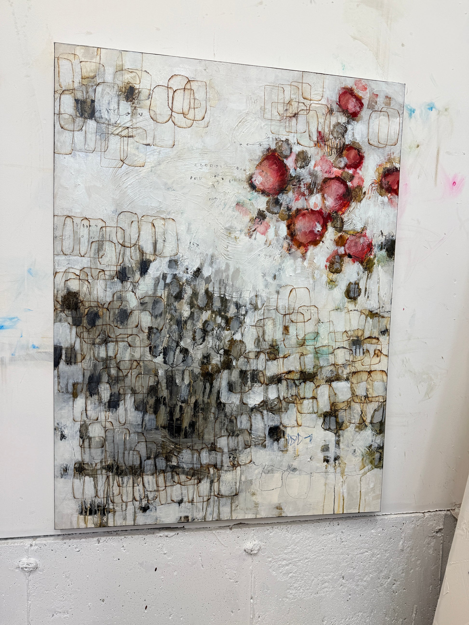 Abstract art piece on a white surface with various textures and colors.