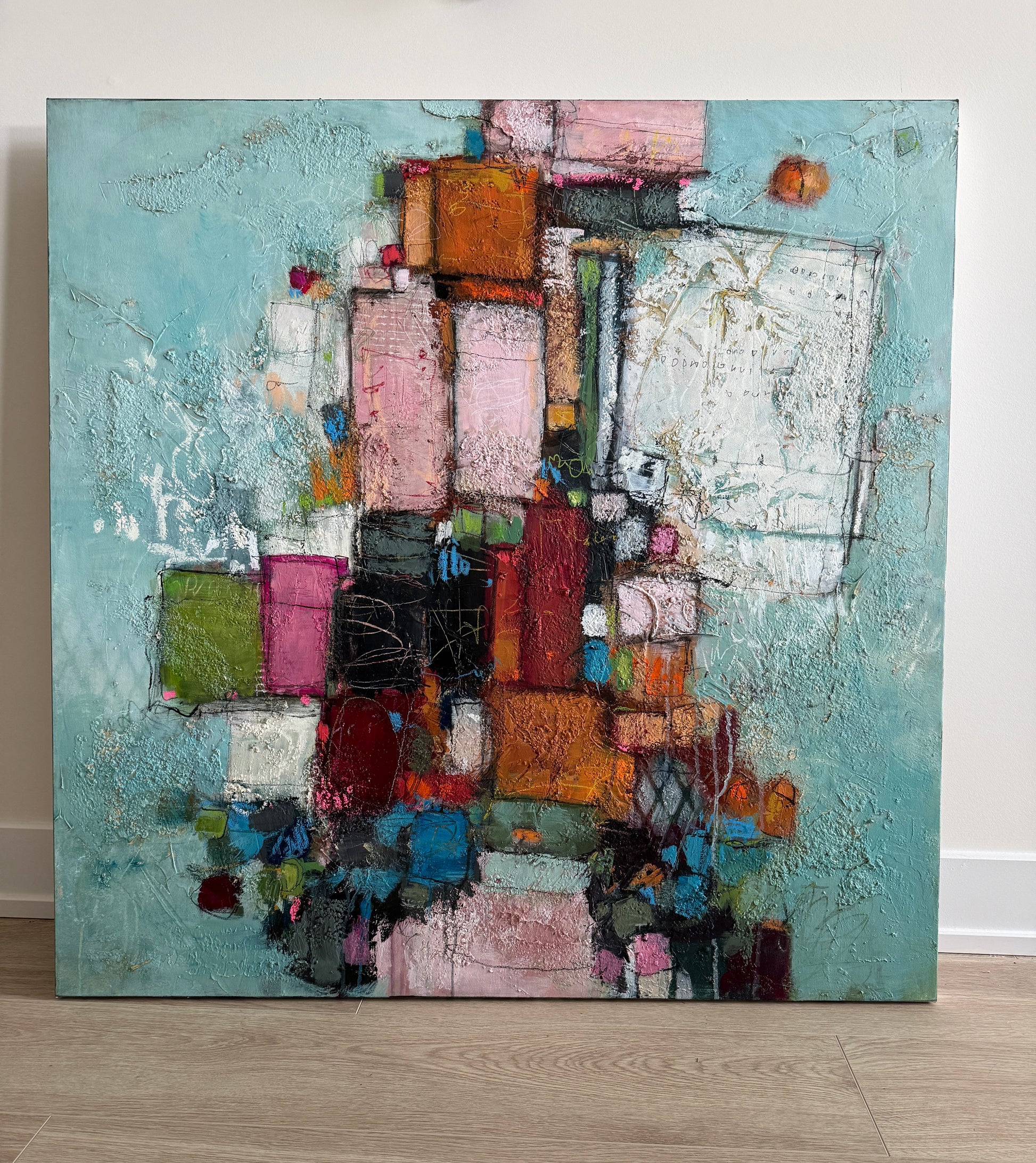 Abstract painting with colorful blocks on a light blue background