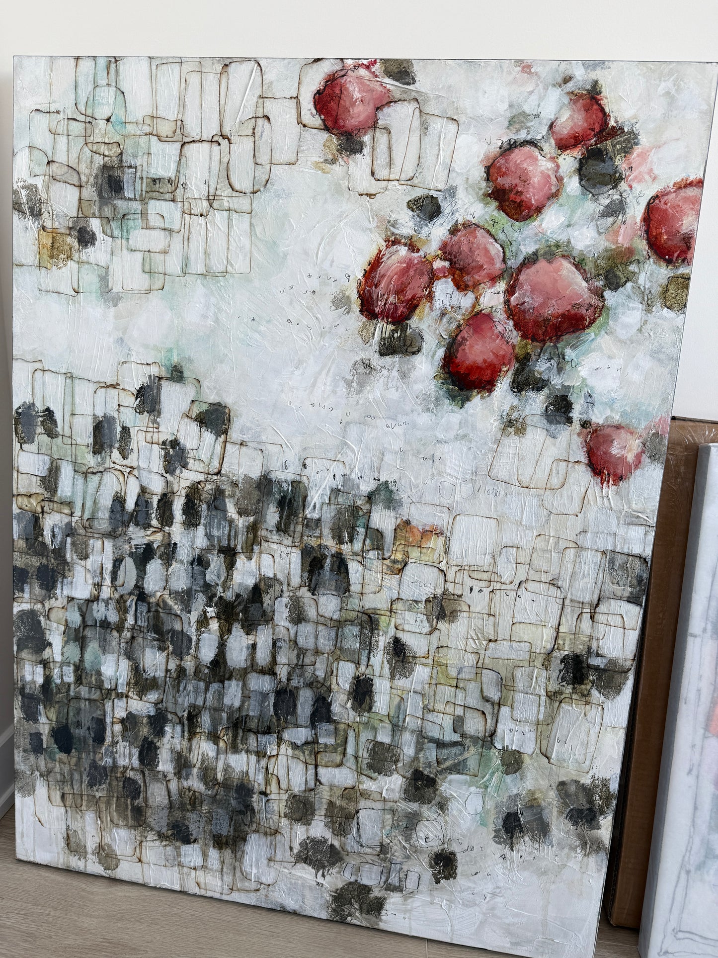 Artistic mosaic with red and black patterns on a white background