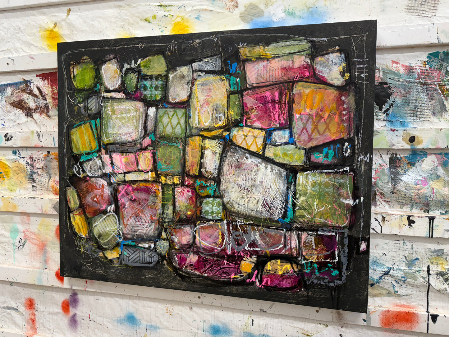 Abstract art piece with colorful geometric shapes on a black background Lori Mirabelli