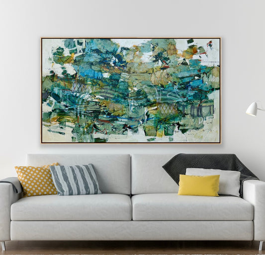 A large 36 x 60” abstract acrylic painting featuring layered greens, blues, whites, and hints of ochre. The piece has a dynamic, organic feel with visible mark-making and movement, blending structured lines with expressive brushwork. Displayed on a white studio wall above wooden steps. Lori mirabelli