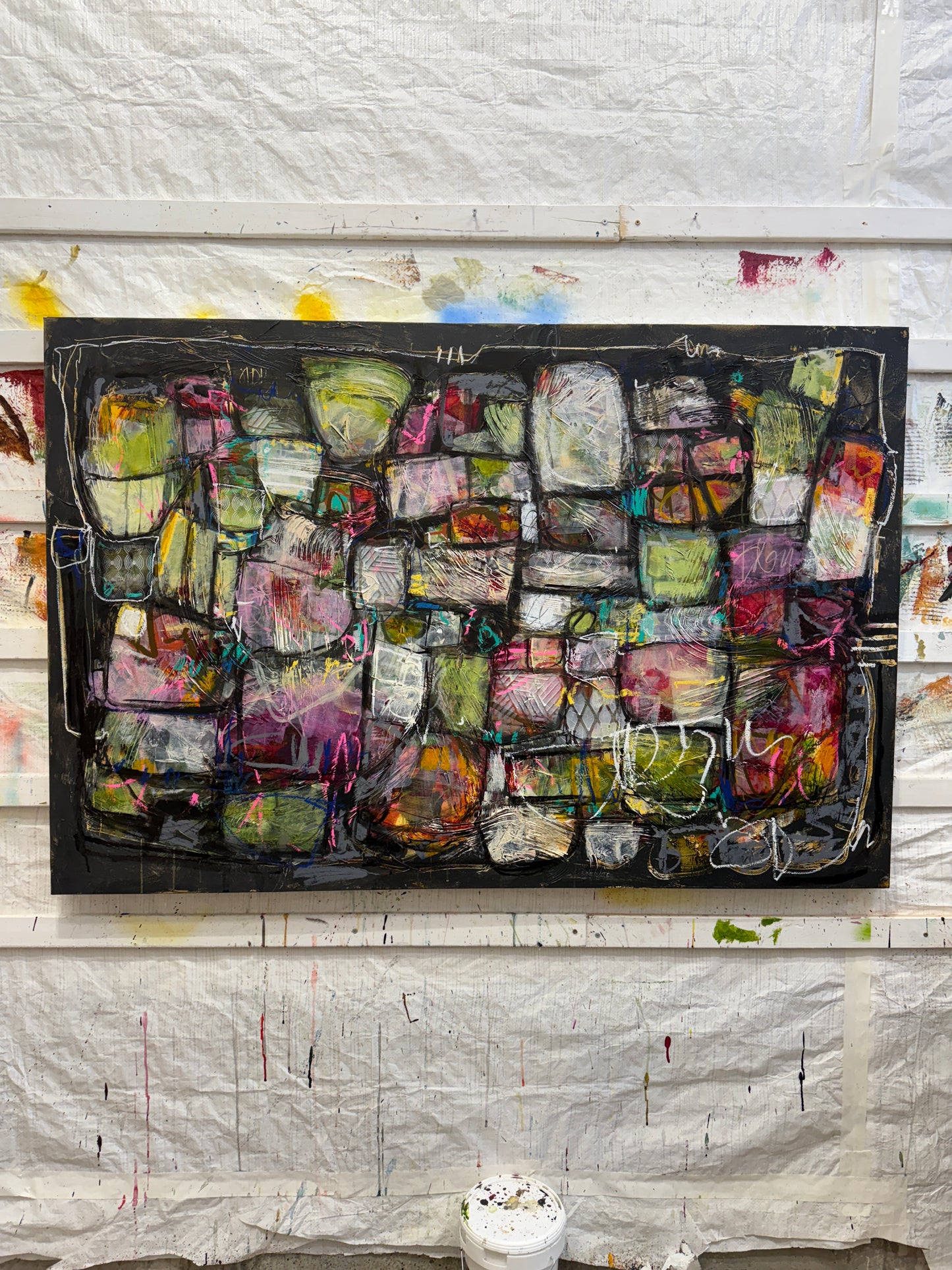 Person sitting in front of a large abstract artwork on a white wall. 40x60 abstract paintings for sale lori mirabelli