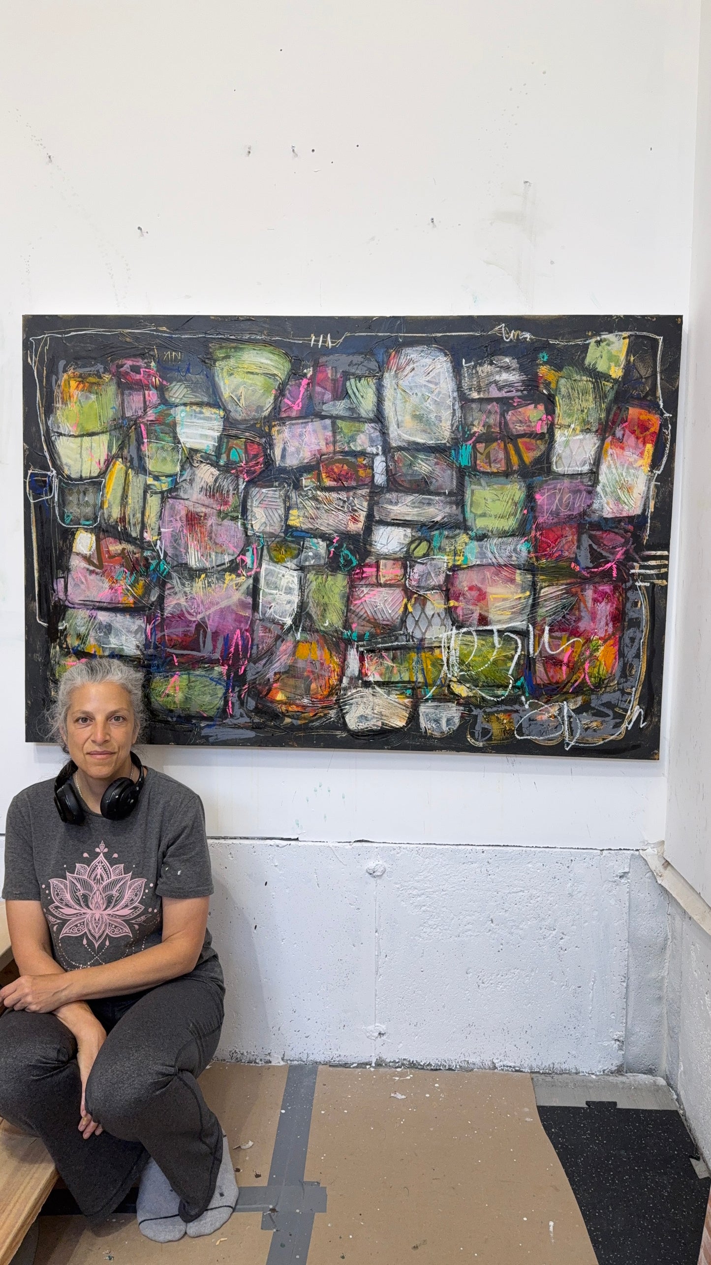 Person sitting in front of a large abstract artwork on a white wall. 40x60 abstract paintings for sale lori mirabelli
