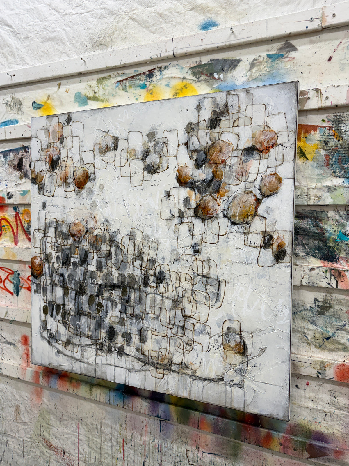 Large contemporary abstract painting with layered black linework, textured white background, soft grey forms and warm rust and ochre accents. Original modern abstract art by Canadian artist Lori Mirabelli, available for collectors and contemporary interiors in Stamford, Connecticut and Greenwich, Connecticut.