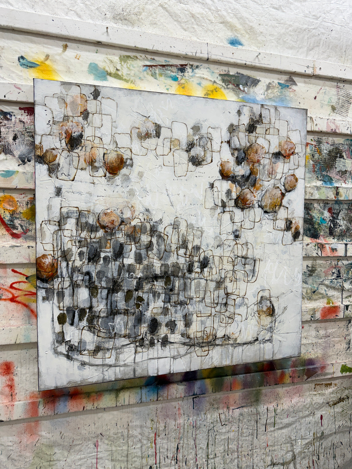 Large contemporary abstract painting with layered black linework, textured white background, soft grey forms and warm rust and ochre accents. Original modern abstract art by Canadian artist Lori Mirabelli, available for collectors and contemporary interiors in Stamford, Connecticut and Greenwich, Connecticut.