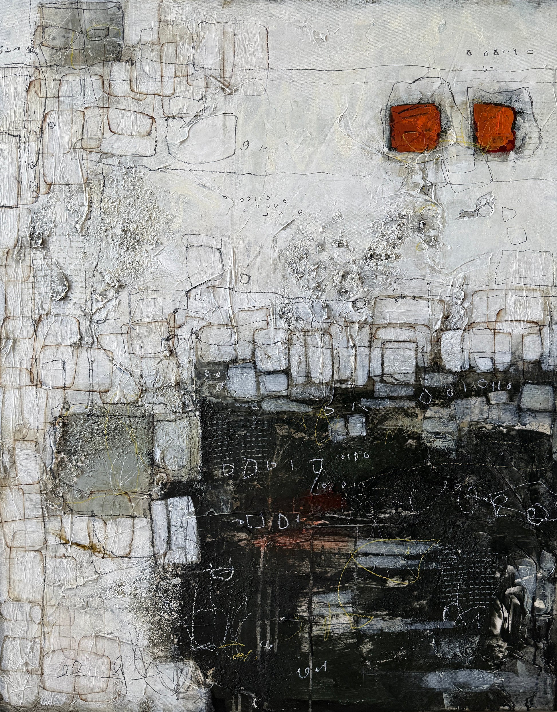 Abstract art piece with textured surface on a light wood floor