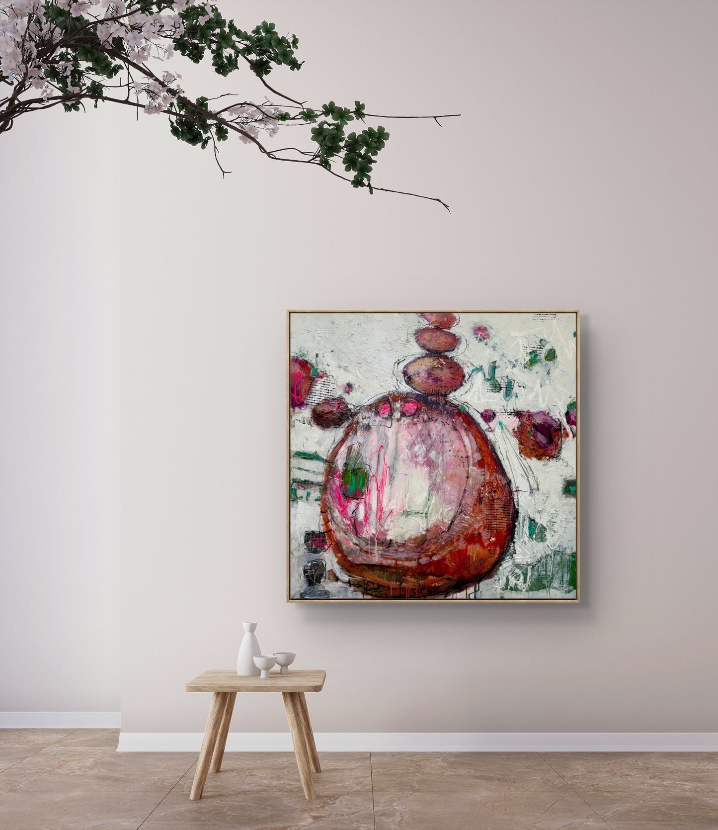 Abstract painting on a wall with a small wooden table and decorative items below.