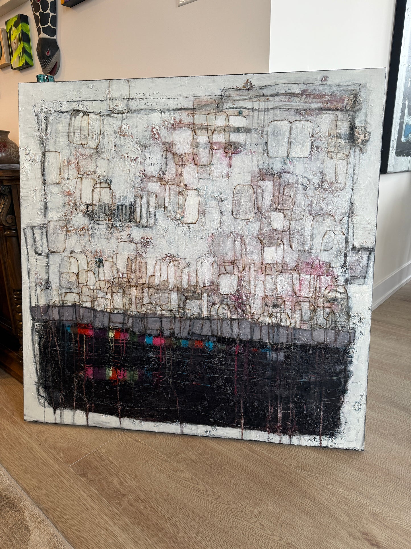 Artistic depiction of a textured wall with geometric patterns on a wooden surface