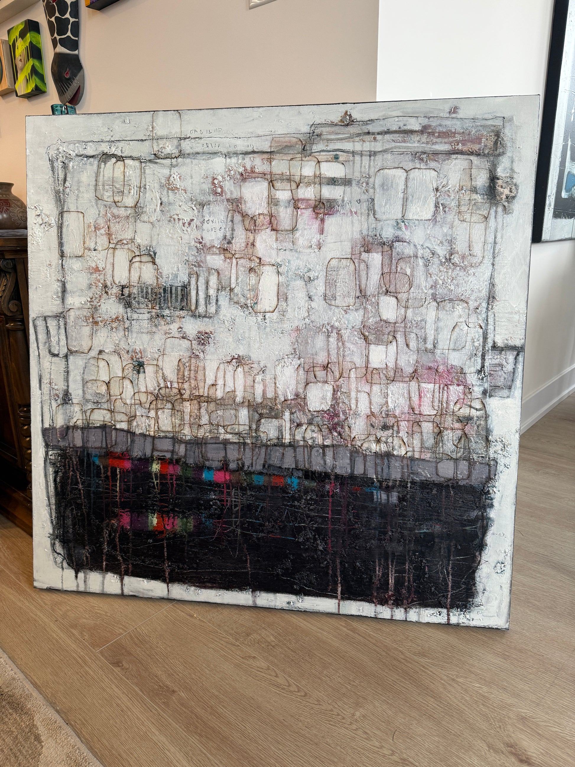 Artistic depiction of a textured wall with geometric patterns on a wooden surface