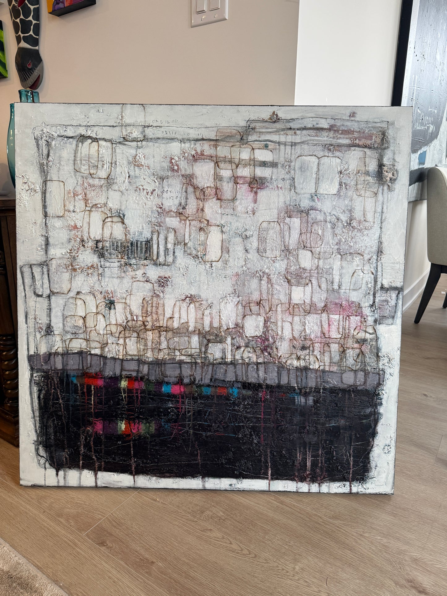 Abstract art piece on a wooden surface with a neutral background