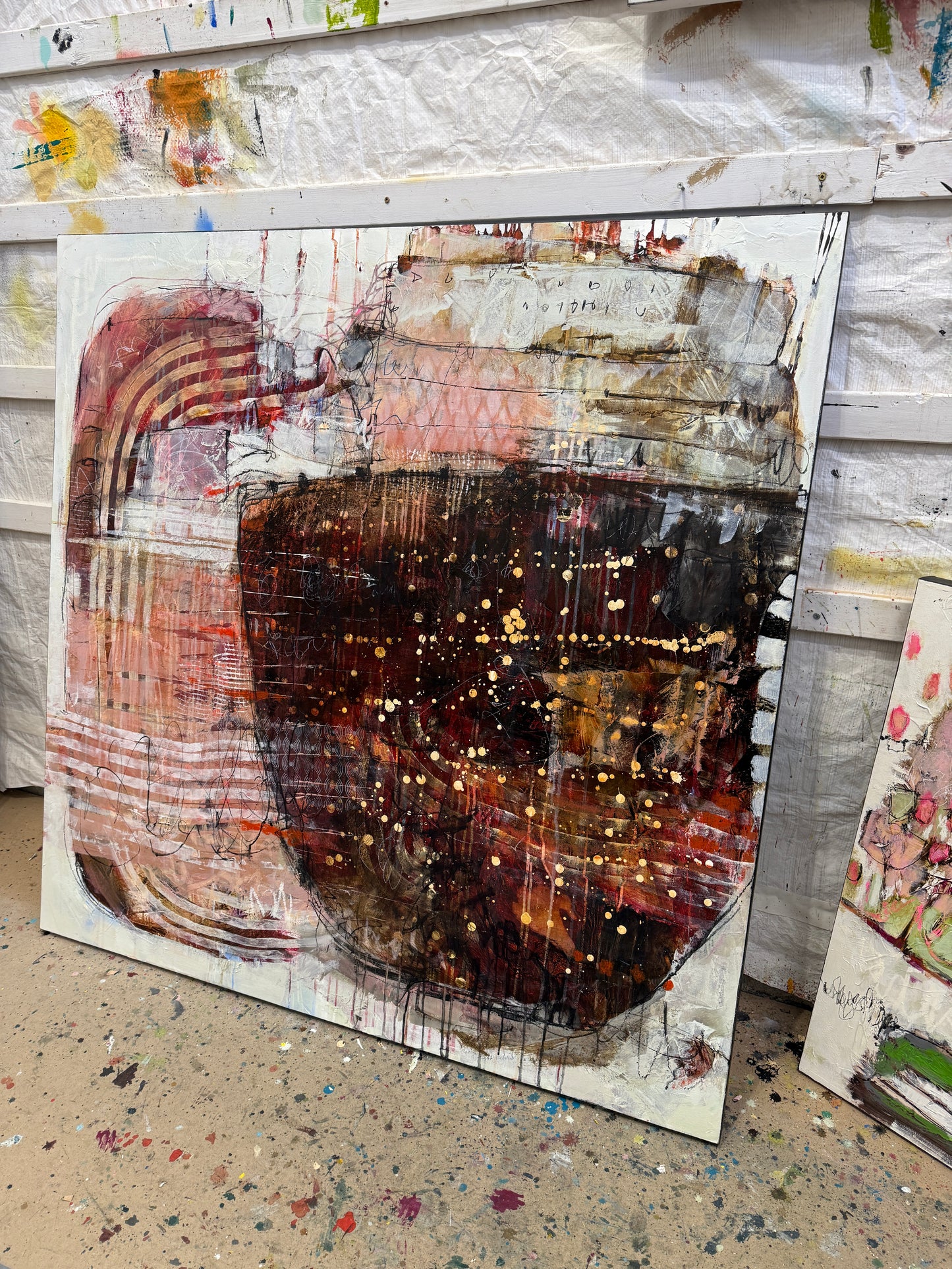 Abstract art piece with a central dark circular shape and layered textures. Lori Mirabelli Toronto 48x48