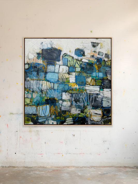 Abstract painting with blue and green tones on a white wall