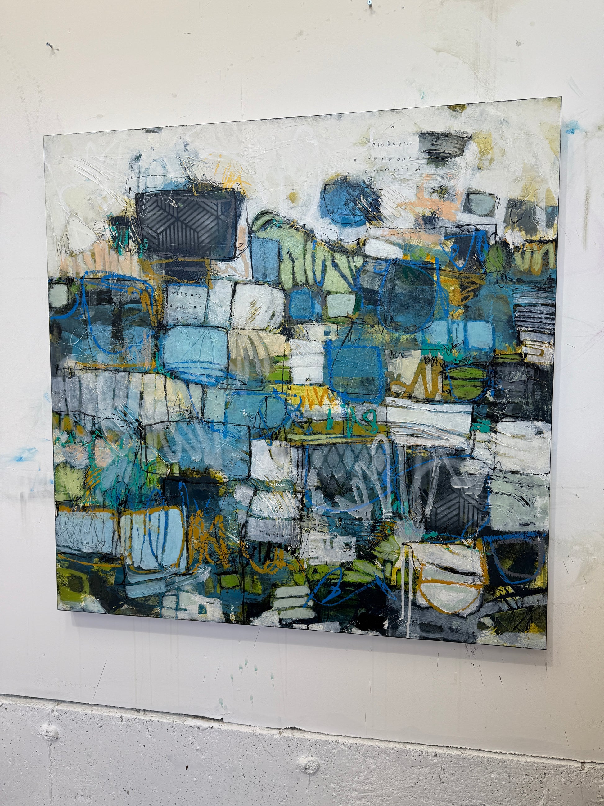 Abstract art piece with blue and green tones on a white background