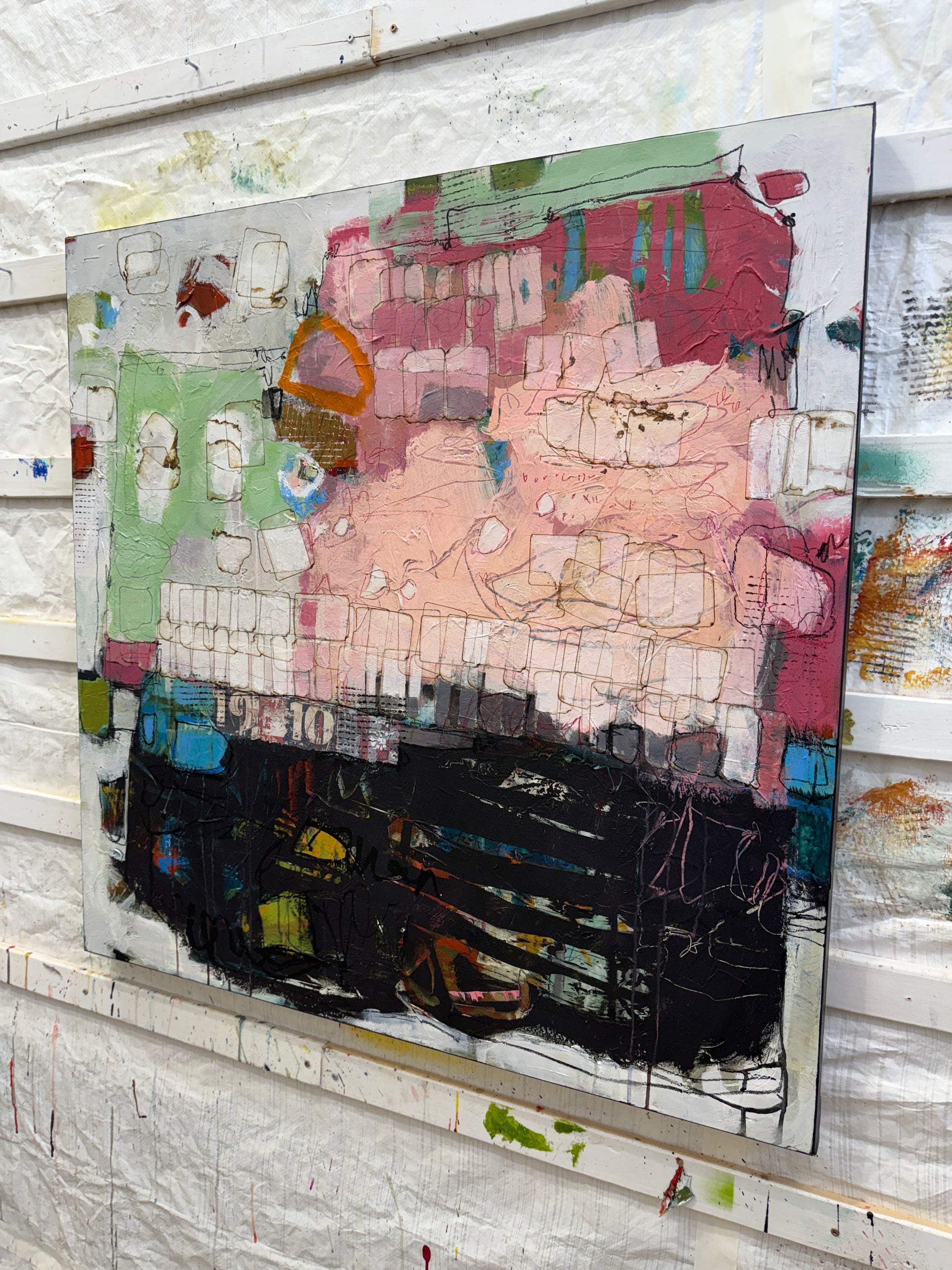 Abstract artwork with colorful patterns on a textured surface