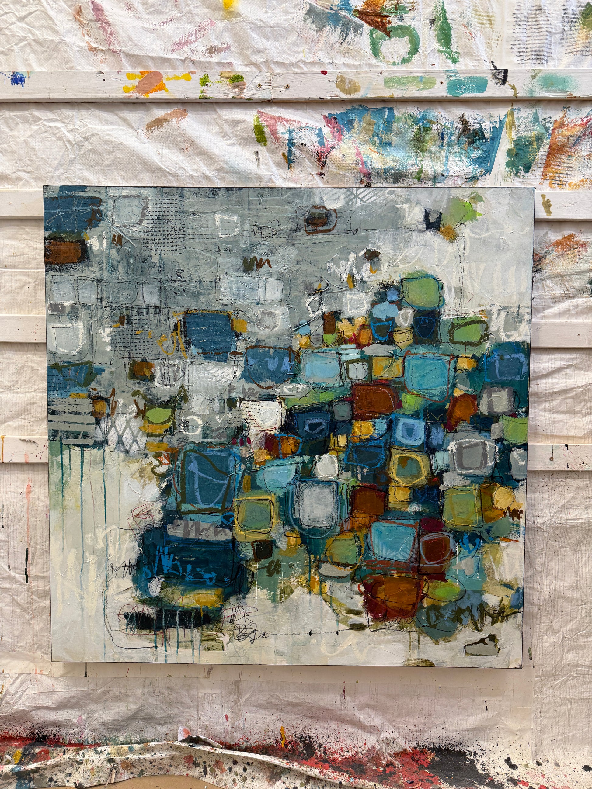 Abstract art piece with geometric shapes on a textured surface
