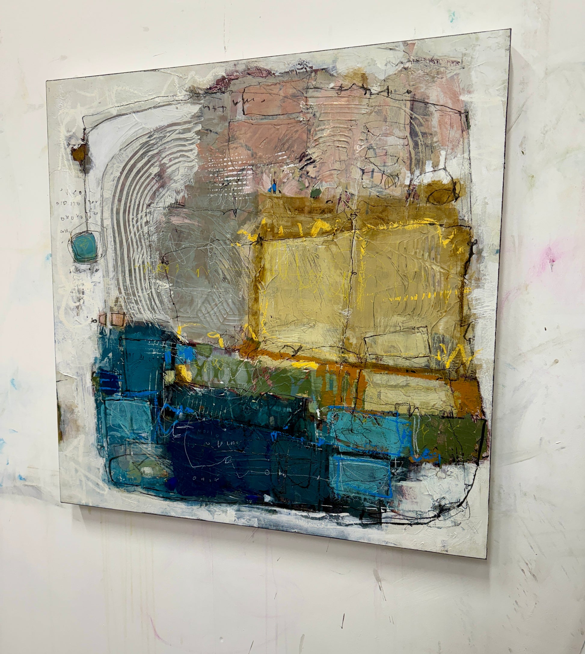 Abstract painting with a mix of colors on a white wall