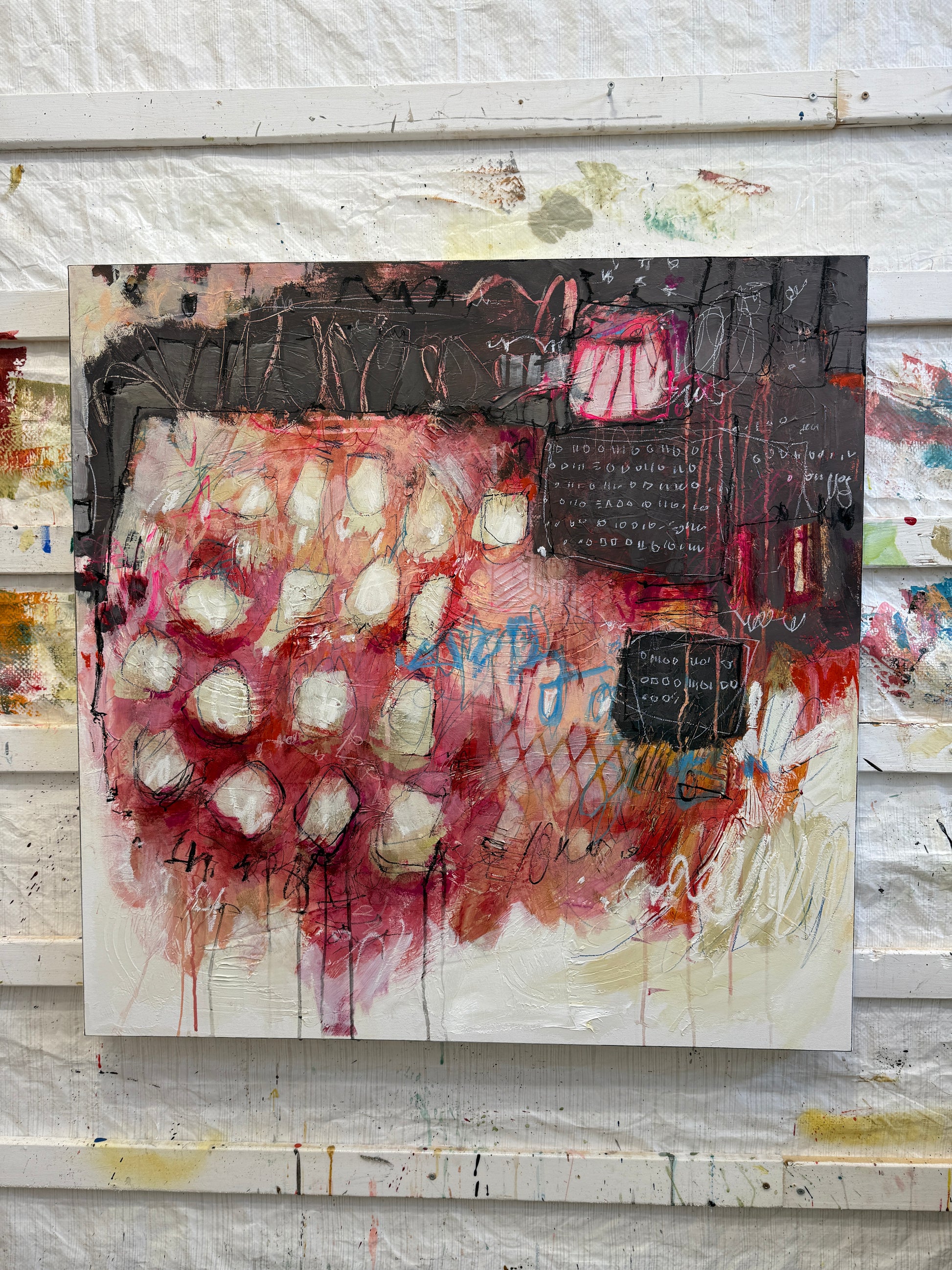 Abstract art piece on a textured wall